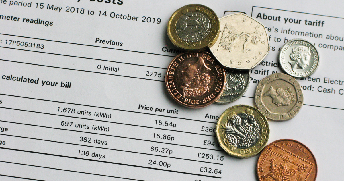 Coins on top of an electricity bill